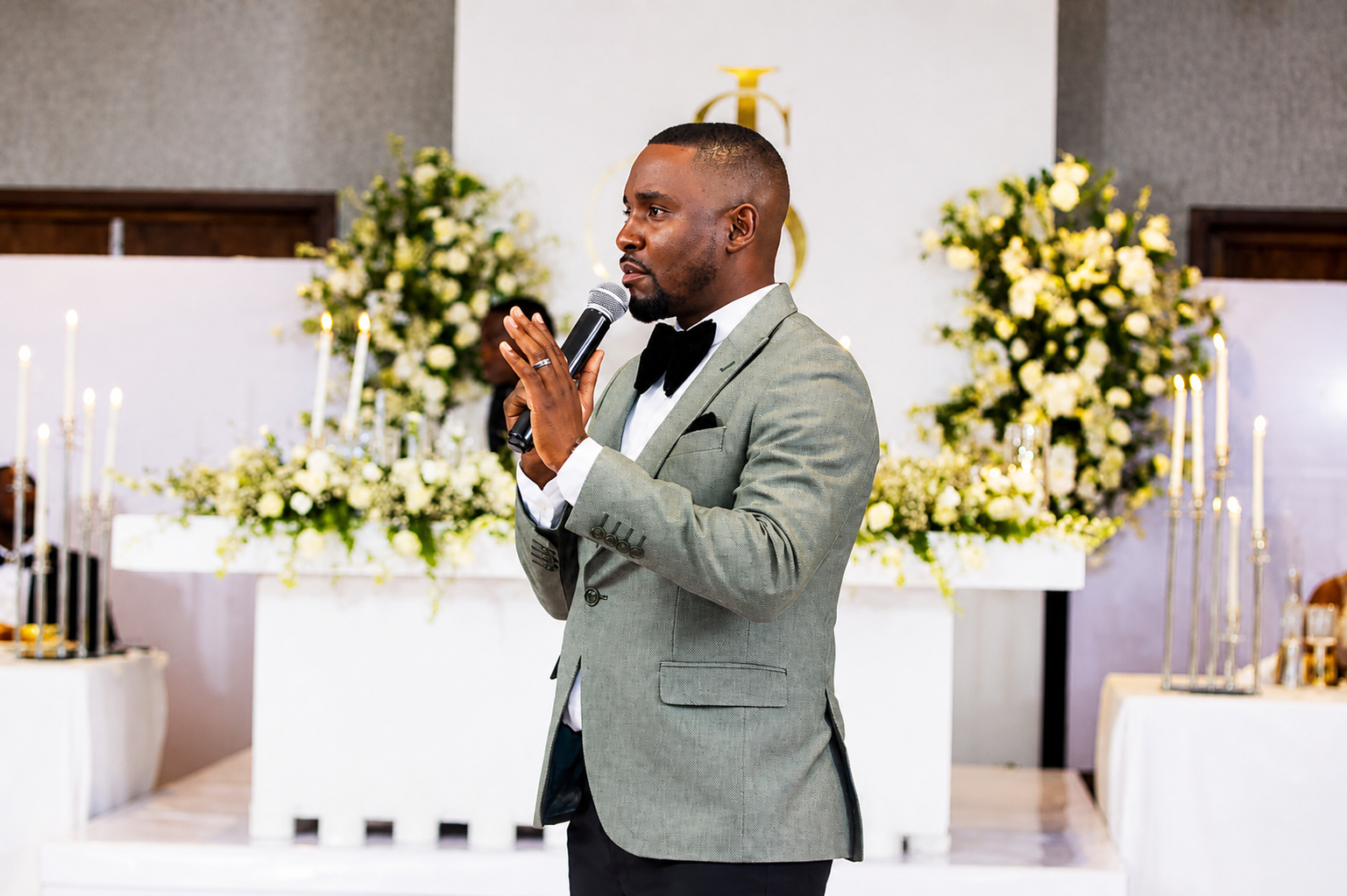 Ken Dumbo on stage hosting a premium event